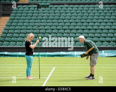 Tennis - 2012 Wimbledon Championships - Day Three - The All England Lawn Tennis and Croquet Club. Ground staff measure the ball's bounce during day three of the 2012 Wimbledon Championships at the All England Lawn Tennis Club, Wimbledon. Stock Photo