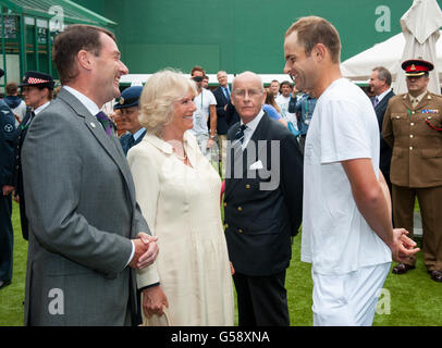 Camilla, the Duchess of Cornwall accompanied by Chairman of the All England Club Philip Brook (left) meets the USA's Andy Roddick (right) on day three of the 2012 Wimbledon Championships, at the All England Lawn Tennis Club, Wimbledon, London. Stock Photo
