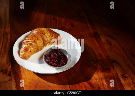 Croissants and jam for breakfast on white plate. Copy space. Stock Photo