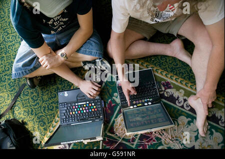 Attendees of the 6th edition of HOPE, an annual hackers' convention, configure their laptops, July 23rd 2006, New York City, USA Stock Photo