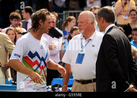 Argentina's David Nalbandian (left) talks to the ATP's Tom Barnes (centre) and Tournament Director Chris Kermode (right) after losing the match by default after an incident involving a line judge needing medical treatment for a cut to the leg during the final on day seven of the AEGON Tennis Championships 2012 at The Queen's Club, London Stock Photo