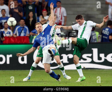 Republic of Ireland's Robbie Keane clears under pressure from Italy's Ignazio Abate during the UEFA Euro 2012 Group match at the Municipal Stadium, Poznan, Poland. Stock Photo