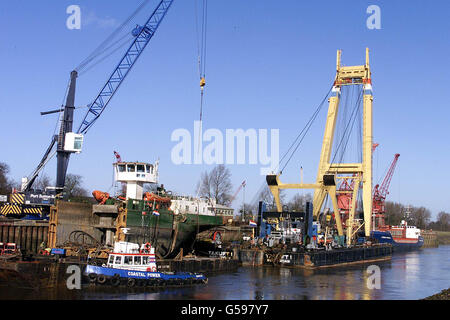 Salvage experts completing the recovery of the stranded freighter Lagik, which has blocked a river for more than a month. Engineers have sliced the 2,500 ton German ship Lagik into three sections and lifted them clear of the River Nene at Sutton Bridge, Lincs. * The ship got stuck across the river while carrying steel to Wisbech, Cambs, in November. A Dutch salvage team has spent more than a week lifting sections of the boat on to a barge ready for removal by road. Stock Photo