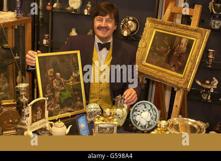 Chairman of Sotheby's South, Tim Wonnacott, poses with some of the many antiques he discovered in a hidden vault at a house in Blackburn. The haul, amassed by antique dealer Joe Marshall, is to be auctioned off at Sothebys and is expected to raise around 500,000. Stock Photo