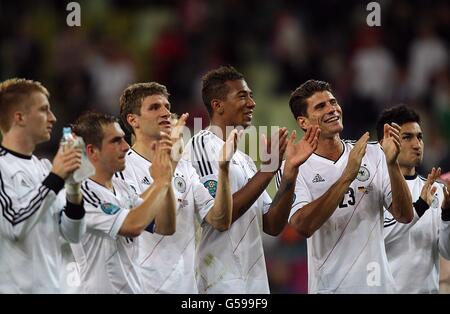 Soccer - UEFA Euro 2012 - Quarter Final - Germany v Greece - Arena Gdansk. Germany's Mario Gomez (right), Jerome Boateng (centre) and Thomas Muller (third from left) celebrate with his team-mates after the game Stock Photo