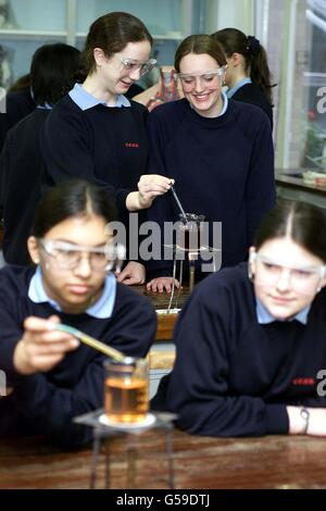 Pupils Jessica Neal (rear left) and Jane Macallan (right) during a science lesson at Colchester County High School For Girls, which has been singled out by Ofsted inspectors as being outstanding and improving. * ...and was among dozens of schools praised by Chief Inspector of Schools Mike Tomlinson in his annual report. School standards minister Estelle Morris welcomed the report covering the 1999-2000 school year saying it showed teaching and results were improving at many schools in England. Stock Photo