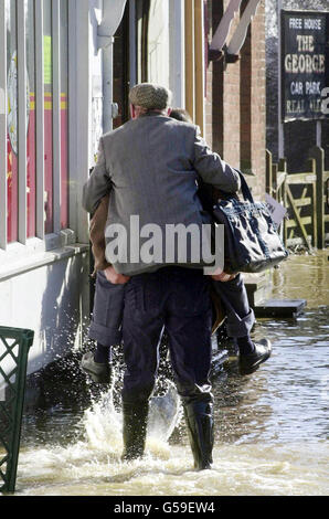 Villagers in Yalding, Kent wade through flood water to the local shop. Families in the village, which saw the worst of the flooding at the end of last year have been warned by the Environment Agency that the high tide between 10am and noon could cause flooding * ... along the already swollen River Medway and smaller contributing rivers. Despite the end of heavy rainfall the water has nowhere to flow and residents have been warned that they could see flooding on a similar level to the end of October last year. Stock Photo