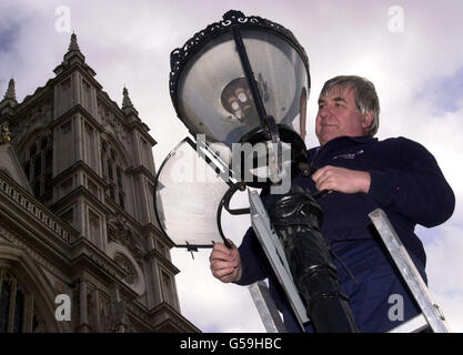Phil Banner a lamplighter in London, checks a gas lamp outside Westminster Abbey, central London. Union leaders have re-ignited a pay claim for workers who maintain gas lamps dating back to 1765. * A bright spark at the GMB union discovered that a claim for one farthing submitted by the Careful Society of Lamplighters 236 years ago had not been settled. The union, which represents four workers who still light and maintain gas lamps outside Buckingham Palace in London and in the capital's Royal Parks, has written to British Gas about the 'outstanding' grievance. Stock Photo