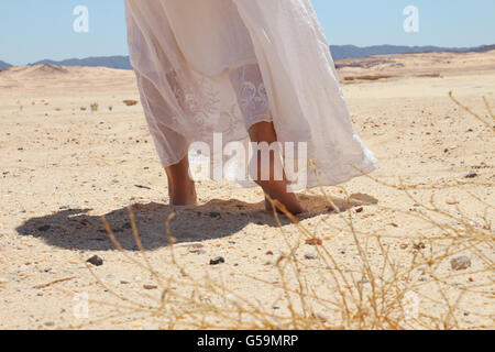 Walking in desert - woman's feet Stock Photo