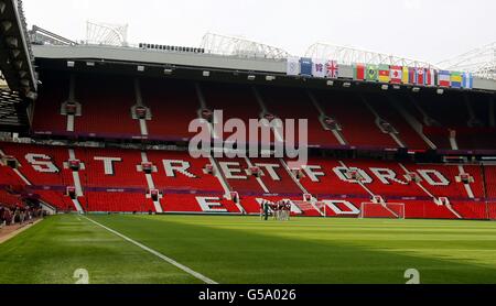 London Olympic Games - Pre-Games competitions - Thurs. A general view of Old Trafford, Manchester with Olympic and Countries flags on the Stretford End. Stock Photo