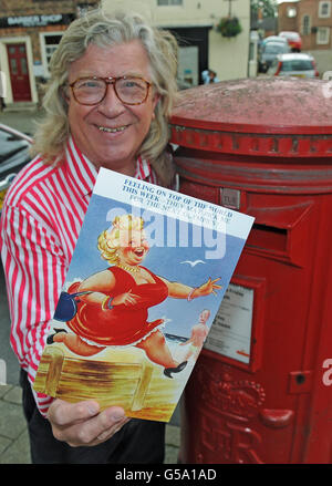 Ian Wallace, owner of saucy seaside postcard company Bamforth, holds a recently found rare postcard first published in 1962, two years before the Tokyo Olympic Games. The card is being posted to Andrew Hunt, the BOA's Chief Executive wishing Team GB all the luck in the world and a successful Olympic Games. 'A happy team is a successful team. We hope that they like the greeting and win many medals,' said Mr Wallace. Stock Photo