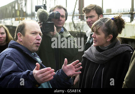 Local Pig Farmer Mick Proctor (left) talks to one of the animal rights activists outside Diss Railway Station, before the activists went to protest outside the pharmaceutical firm Huntingdon Life Sciences headquarters in Huntingdon. * ...Cambridgeshire, as part of their campaign against HLS. Stop Huntingdon Animal Cruelty, the group organising the protest are calling for the company, which tests drugs on a nimals, to be shut down. The activists defied pleas from farmers and police by travelling from all parts of Britain to stage the protest against the a controversial pharmaceutical testing Stock Photo