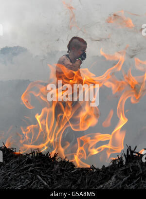 A participant tackles the Firewalker obstacle during the 2012 Tough Mudder Extreme Endurance Challenge held in the grounds of Drumlanrig Castle and Country Estate in Dumfriesshire. PRESS ASSOCIATION Photo. Picture date: Saturday July 14, 2012. The 12 mile obstacle course is designed by Special Forces to test fitness, stamina and mental strength. Over 5,000 participants are taking part throughout the weekend, with 100,000 gallons of mud, participants braved waist high swamps, underground tunnels, Fire walking and electric shocks amongst the 22 obstacles. Photo credit should read: Andrew Stock Photo