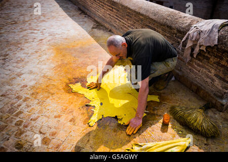 Fez, Morocco - April 11, 2016: One man working in a tannery in the city of Fez in Morocco. Stock Photo