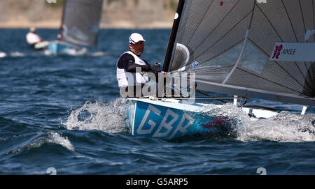 Great Britain's Finn sailor Ben Ainslie in action during the second race in the Olympic sailing event off Weymouth. Stock Photo