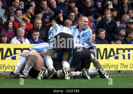 Coventry City player's celebrate their third goal by piling up on top of their goal scorer John Hartson, (Craig Bellamy looking up), during the FA Carling Premiership game at Filbert Street, Leicester. Stock Photo