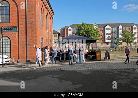 People having a drink outside the Pump House Pub and Grill on a June summers evening at Swansea Marina, Wales UK  KATHY DEWITT Stock Photo