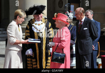 Queen Elizabeth II, accompanied by the Duke of Edinburgh, is presented with a gift on behalf of Birmingham by Chair of the Birmingham Assay Office, Ms Kay Alexander, in Victoria Square, Birmingham. Stock Photo