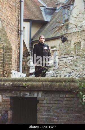 A member of the security team on the roof of a building next to the Oxford Union, prior to the arrival of American pop star Michael Jackson to give a talk. Stock Photo