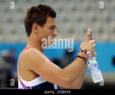 London Olympic Games - Pre-Games competitions - Weds. Great Britain's Tom Daley takes a photo as he watches during a practice session at the Aquatic Centre, Olympic Park, London. Stock Photo