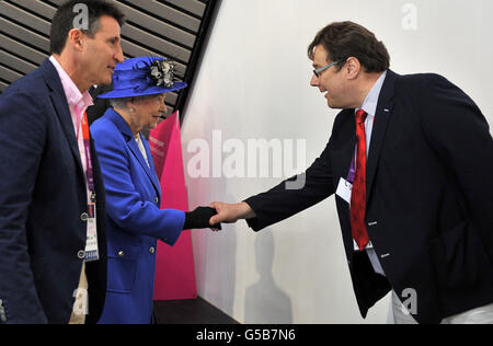Queen Elizabeth II meets Chief Executive of British Swimming David Sparkes (right) as LOCOG Chairman Lord Sebastian Coe (left) looks on at the Aquatics Centre in London on day one of the London 2012 Olympics. Stock Photo