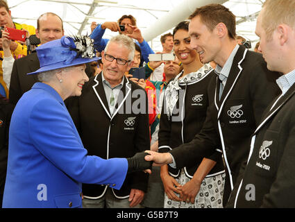 Queen Elizabeth II meets the Nick Willis of New Zealand, as she and the Duke of Edinburgh tour the Athletes Village dinning hall in Stratford east London. Stock Photo