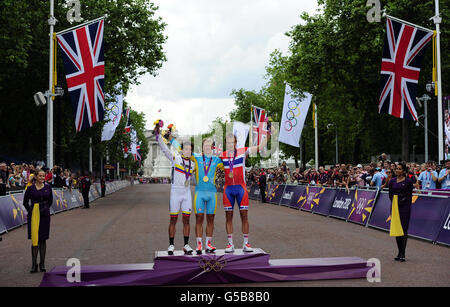 Kazakhstan's Alexandr Vinolurov celebrates winning Gold (centre) alongside second placed Rigoberto Uran Uran and third placed Norway's Alexander Kristoff following the Men's Road Race in the Mall, London. Stock Photo