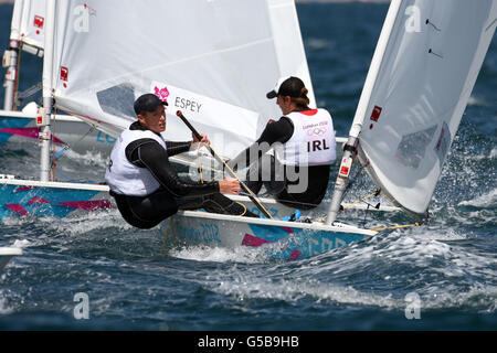 Great Britain's Paul Goodison (left) and Ireland's James Espey in action in the the Men's Laser, race 2 sailing on the waters off Weymouth and Portland, on the third day of the London 2012 Olympics. Stock Photo