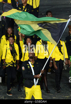 Usain Bolt carries the Jamaican flag during the London Olympic Games 2012 Opening Ceremony at the Olympic Stadium, London. Stock Photo