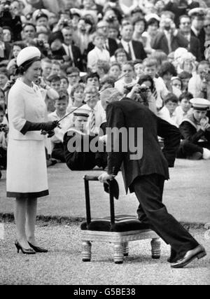 The Queen, using Sir Francis Drake's sword, dubs Sir Francis Chichester who kneels before her to receive the accolade of Knighthood in a ceremony at the Royal Naval College, Greenwich, London. Sir Francis arrived at Greenwich in Gipsy Moth IV in which he sailed alone around the world. Stock Photo