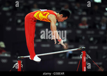 China's Weiyang Guo competes on the horizontal bar during the Artistic Gymnastics team qualification at the North Greenwich Arena, London. Stock Photo