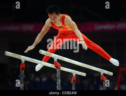 China's Weiyang Guo competes on the parallel bars during the Artistic Gymnastics team qualification at the North Greenwich Arena, London. Stock Photo