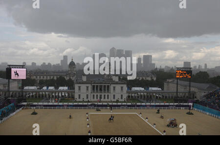 Great Britain's Kristina Cook riding Miners Frolic competes in heavy rain during the Dressage stage of the Eventing at Greenwich Park, London on the second day of the London 2012 Olympics. Stock Photo