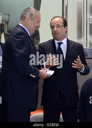French President Francois Hollande (right) attends the swimming at the Aquatics Centre in the Olympic Park, London, on the third day of the London 2012 Olympics. Stock Photo
