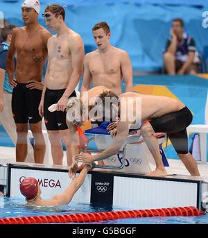 Great Britain's relay team of Ross Davenport, Robbie Renwick, Rob Bale and David Carry celebrate after the Men's 4 x 200m Freestyle Relay Heats during day four of the London 2012 Olympic Games at the Aquatics Centre in the Olympic Park, London. Stock Photo