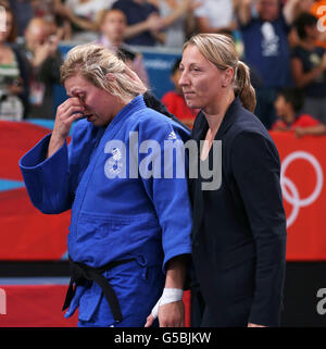 Great Britain's Judo player Gemma Gibbons (left) leaves the arena with coach Kate Howey after losing the final of Women's Judo 78kg category at the ExCel Arena, London, on the sixth day of the London 2012 Olympics. Stock Photo