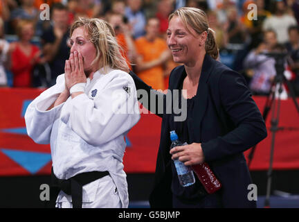 Great Britain's Judo player Gemma Gibbons (left) with her coach Kate Howey after throwing France's Audrey Tcheumeo to win her semi-final of Women's 78kg Judo at the ExCel Arena, London, on the sixth day of the London 2012 Olympics. Stock Photo