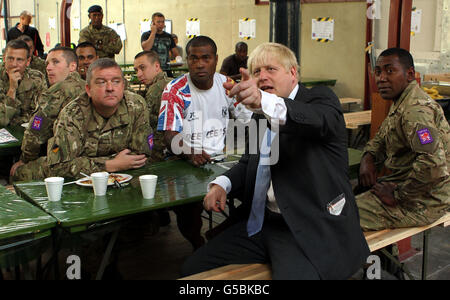 London Mayor Boris Johnson watches Great Britain's Katherine Grainger and Anna Watkins during the women's double sculls at Eton Dorney Rowing Lake, Windsor, during a visit to meet members of the armed forces in Tobacco Dock, Wapping, as a thank you for their help in making the London 2012 Olympic Games secure. Stock Photo