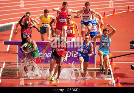 Competitors go over the water jump during heat 2 of Round 1 of the Men's 3000m Steeplechase Stock Photo