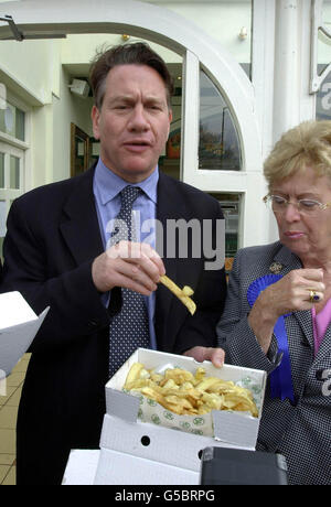 Shadow Chancellor Michael Portillo tries a chip during a visit Harry Ramsden's world famous fish and chip bar in Guiseley near Leeds during his visit to the area on the first full day of General Election campaigning. Stock Photo
