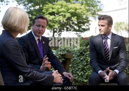 Prime Minister David Cameron, David Beckham and Anita Tiessen, the Deputy Executive Director of UNICEF UK, attend a UNICEF charity meeting in 10 Downing Street in London. Stock Photo