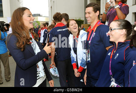 The Duchess of Cambridge laughs as she talks with Great Britain cyclist Victoria Pendleton (right) during a visit to the Team GB accommodation flats in the Athletes Village at the Olympic Park in Stratford, east London. Stock Photo