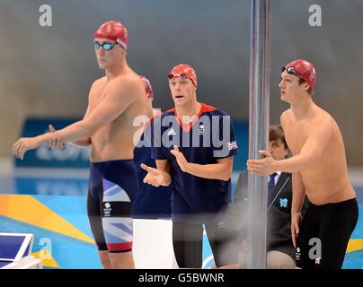 Great Britain's Rob Bale (centre) cheers on his teammate Robbie Renwick (left) before the start of the Men's 4 x 200m Freestyle Relay Final at the Aquatics Centre in the Olympic Park during the fourth day of the London 2012 Olympics. Stock Photo