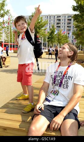 Prince Christian of Denmark strikes the Usain Bolt lightning bolt pose as Danish Athlete Mikkel Hansen laughs during a visit with his parents Crown Prince Frederick and Crown Princess Mary to the London 2012 Olympic athletes village in Stratford, east London. Stock Photo