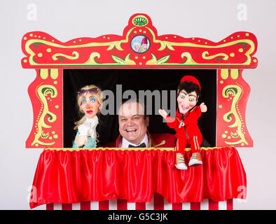Actor Shaun Williamson, who will be starring as the bottler in a modernised Punch and Judy show from comedy channel GOLD which will tour the UK this August, poses with Punch the benefits cheat and Judy the wannabe WAG puppets. Stock Photo