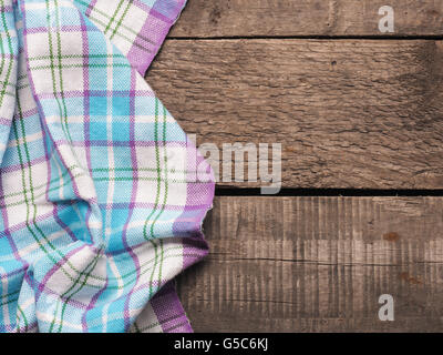 Old fashioned checkered table cloth on a rustic wooden table Stock Photo