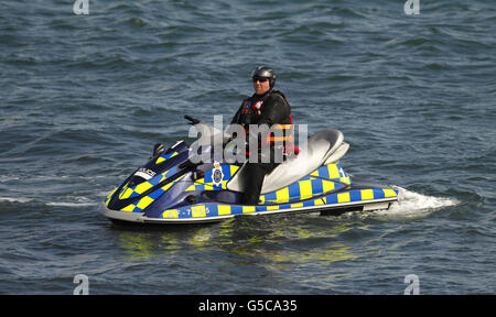 A police officer sits on a jet-ski during the Olympic sailing events on Weymouth Bay today. Stock Photo