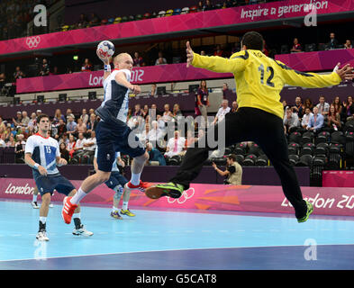Great Britain's Sebastien Edgar about to shoot past Tunisia's Marouen Maggaiz during their Preliminary Group A match at The Copper Box Handball Arena, London. Stock Photo