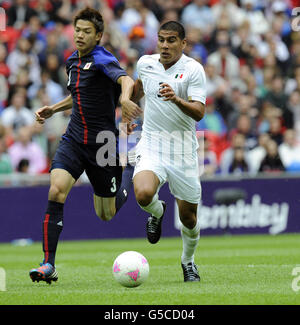 London Olympic Games - Day 11. Japan's Takahiro and Mexico's Carlos Salcedo, during the Men's Football Semi-final at Wembley Stadium. Stock Photo