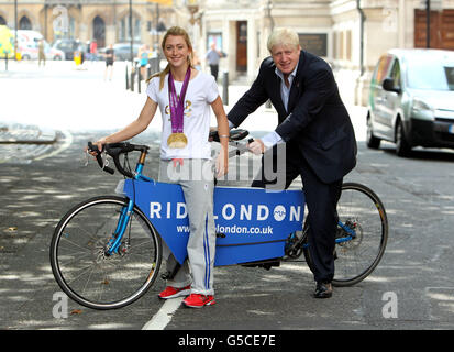 Double gold medal winner Laura Trott in Westminster, central London, with London Mayor Boris Johnson during the announcement of the RideLondon event, an annual cycling event weekend for London which will include a 100-mile 'Marathon' bike ride. Stock Photo